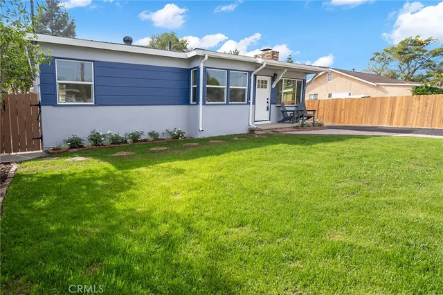 an aerial view of a house with a yard and potted plants