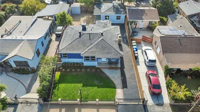 an aerial view of multiple houses with yard