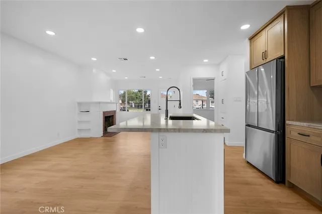 a kitchen with stainless steel appliances a refrigerator sink and stove