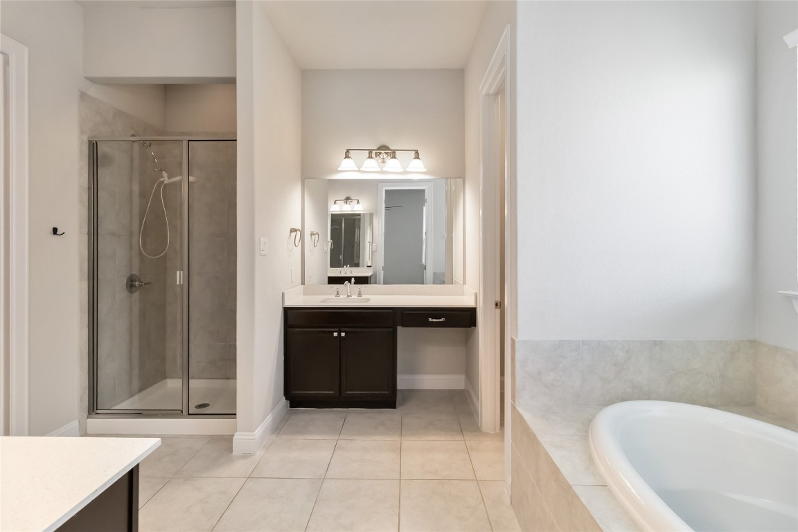 112 Barrel Bend Georgetown, TX 78628 - Photo 29 of 39 a spacious bathroom with a tub sink and mirror