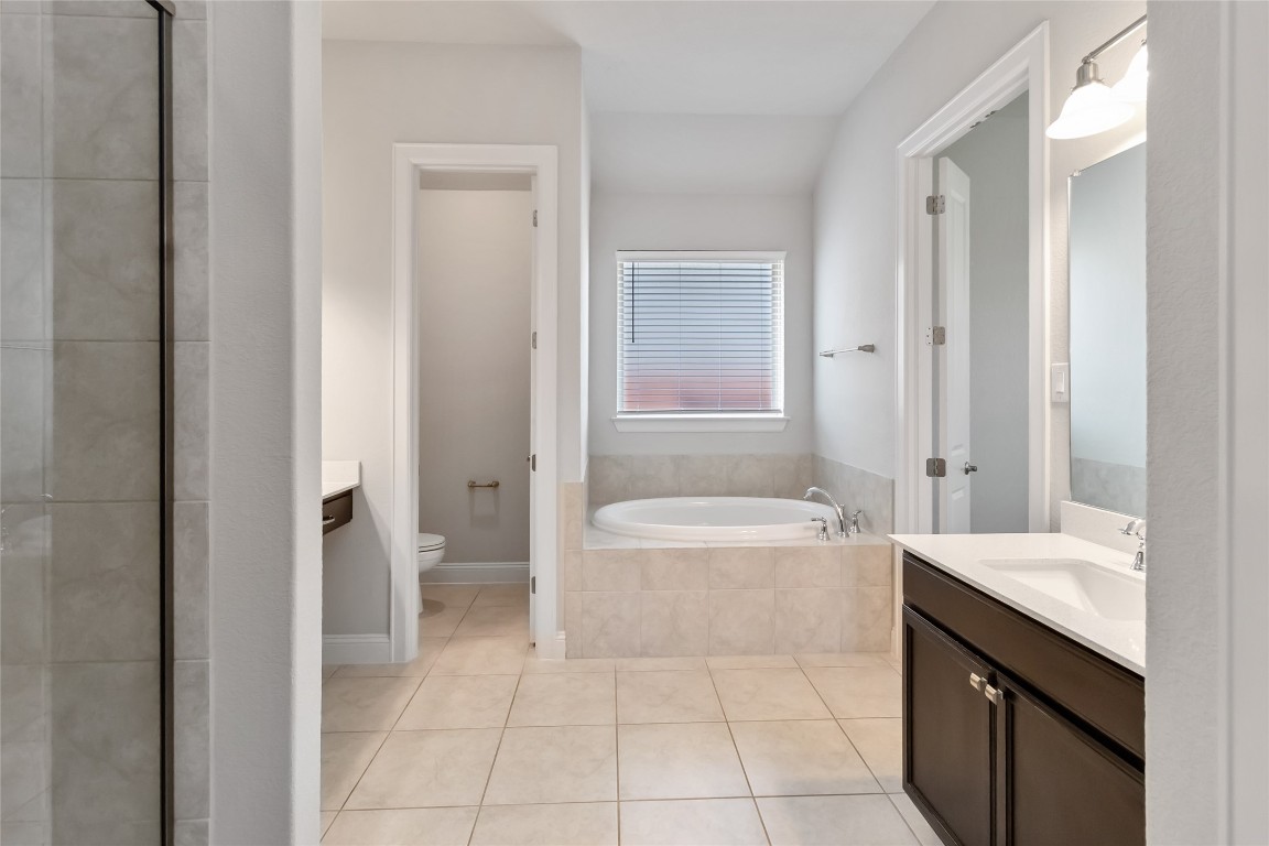 112 Barrel Bend Georgetown, TX 78628 - Photo 30 of 39 a bathroom with a bathtub sink and toilet