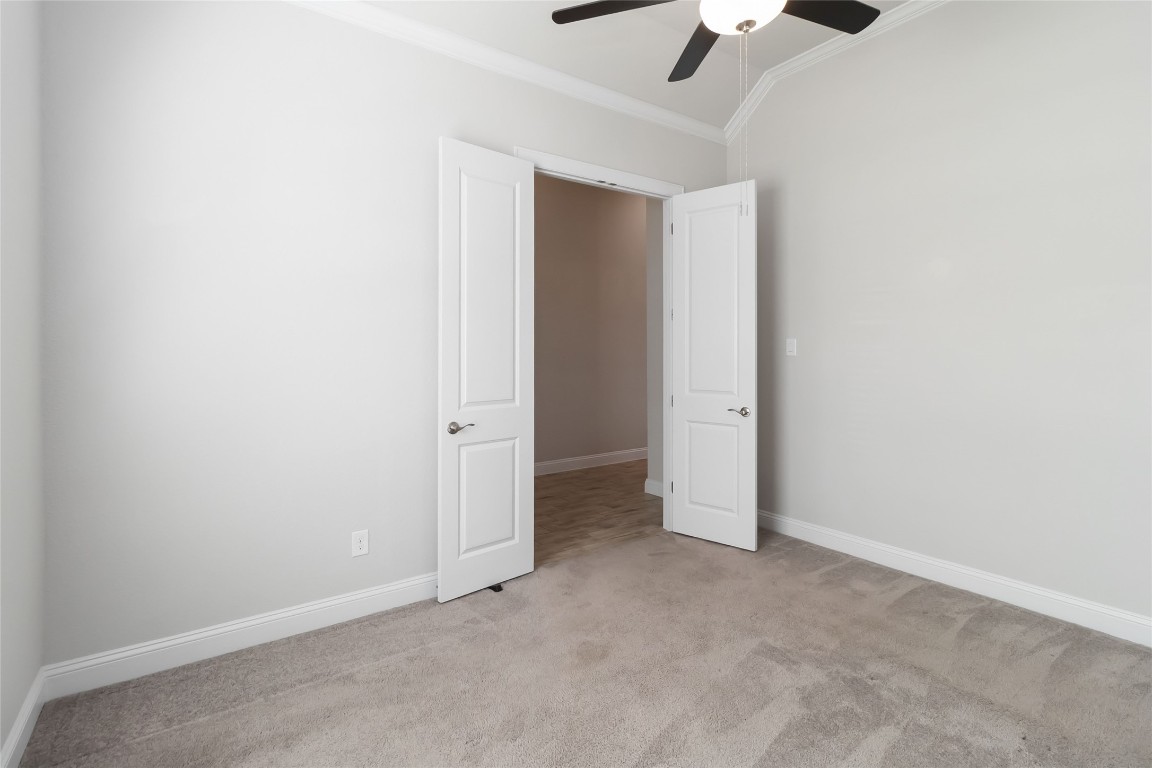 112 Barrel Bend Georgetown, TX 78628 - Photo 9 of 39 an empty room with a ceiling fan and carpet
