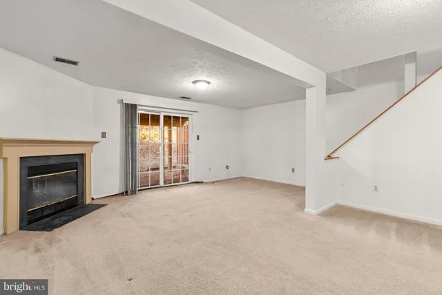 a view of empty room with a fireplace
