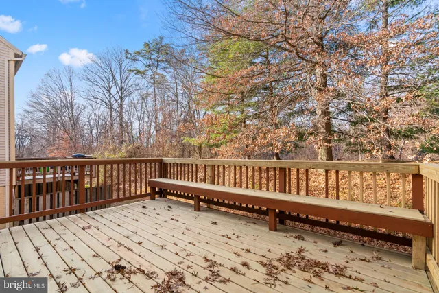 a view of a balcony with wooden fence and floor