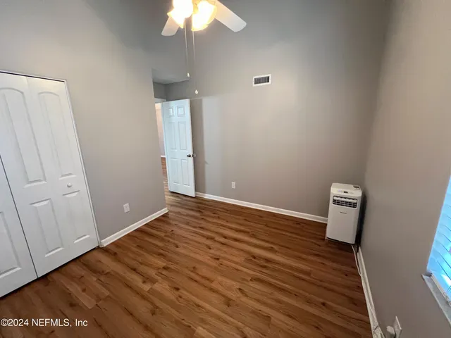 a view of room with wooden floor