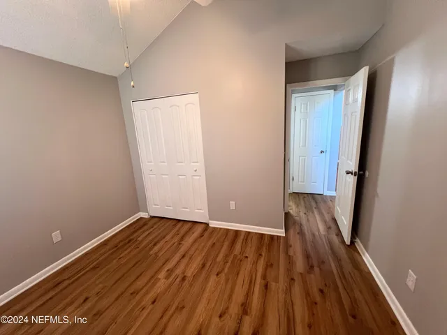a view of a room with wooden floor