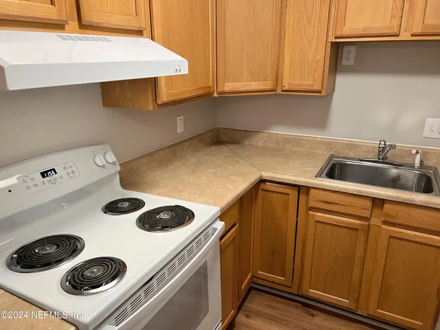 a kitchen with a stove and a refrigerator
