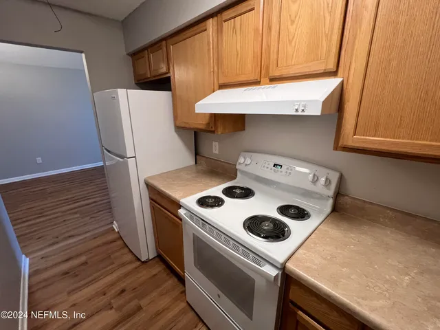 a kitchen with a stove and a microwave