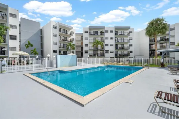 a view of a swimming pool and dining room