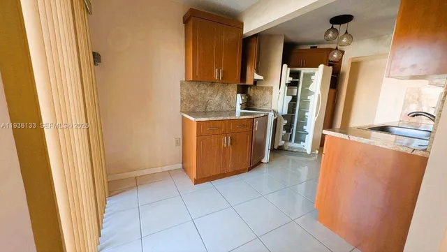 a kitchen with stainless steel appliances a refrigerator and a stove