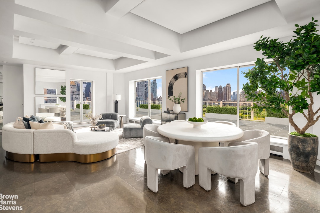 880 5th Avenue, Unit PHF Manhattan, NY 10021 - Photo 1 of 16 a living room with fireplace furniture and a large window