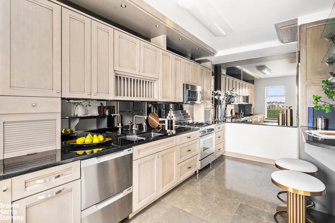 880 5th Avenue, Unit PHF Manhattan, NY 10021 - Photo 3 of 16 a kitchen with stainless steel appliances a white cabinets and a counter space
