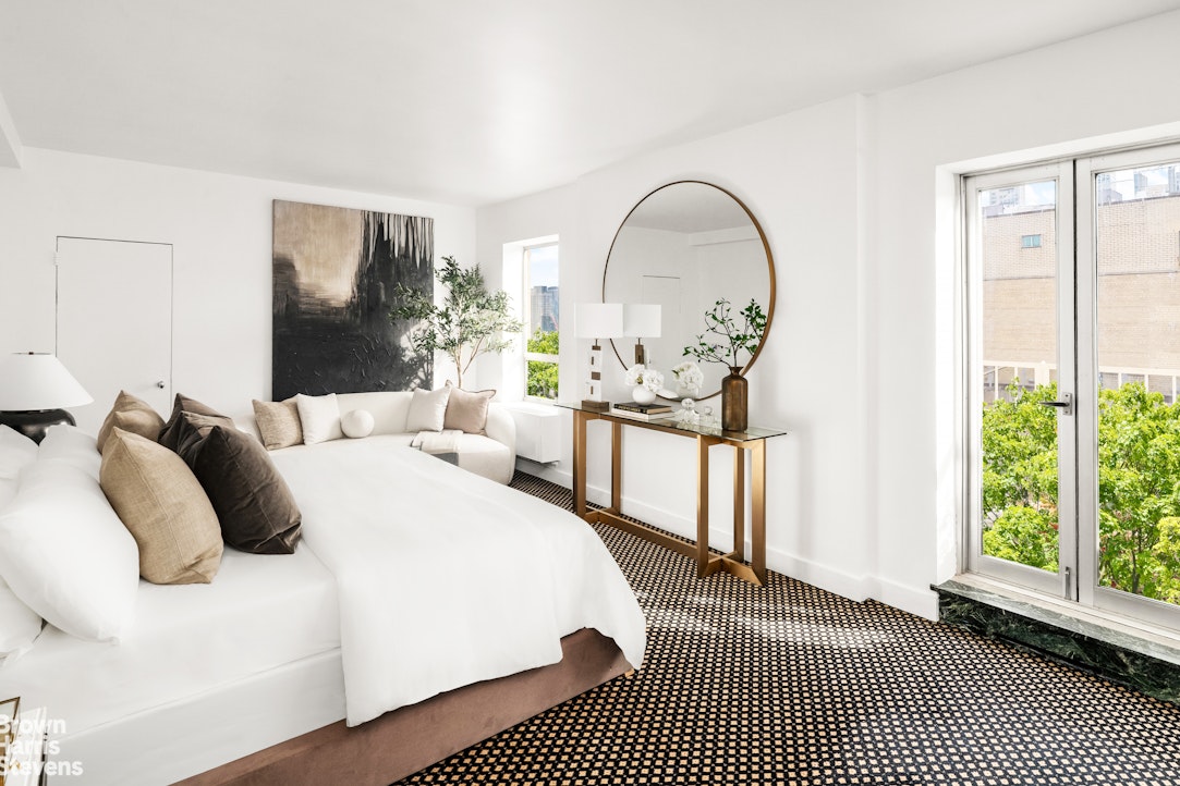 880 5th Avenue, Unit PHF Manhattan, NY 10021 - Photo 5 of 16 a bedroom with a bed a mirror and a large window with outer view