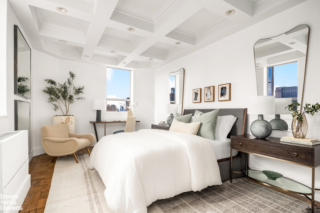 880 5th Avenue, Unit PHF Manhattan, NY 10021 - Photo 9 of 16 a bedroom with a bed and a couch