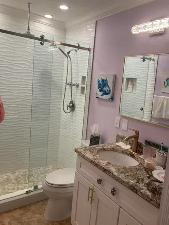 a bathroom with a granite countertop sink and a mirror