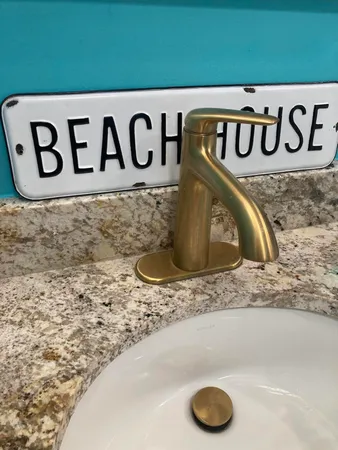 a bathroom with a granite countertop sink a mirror and a shower