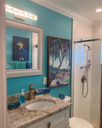 a bathroom with a granite countertop sink toilet and shower
