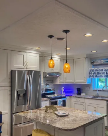 a kitchen with stainless steel appliances granite countertop a sink refrigerator and microwave