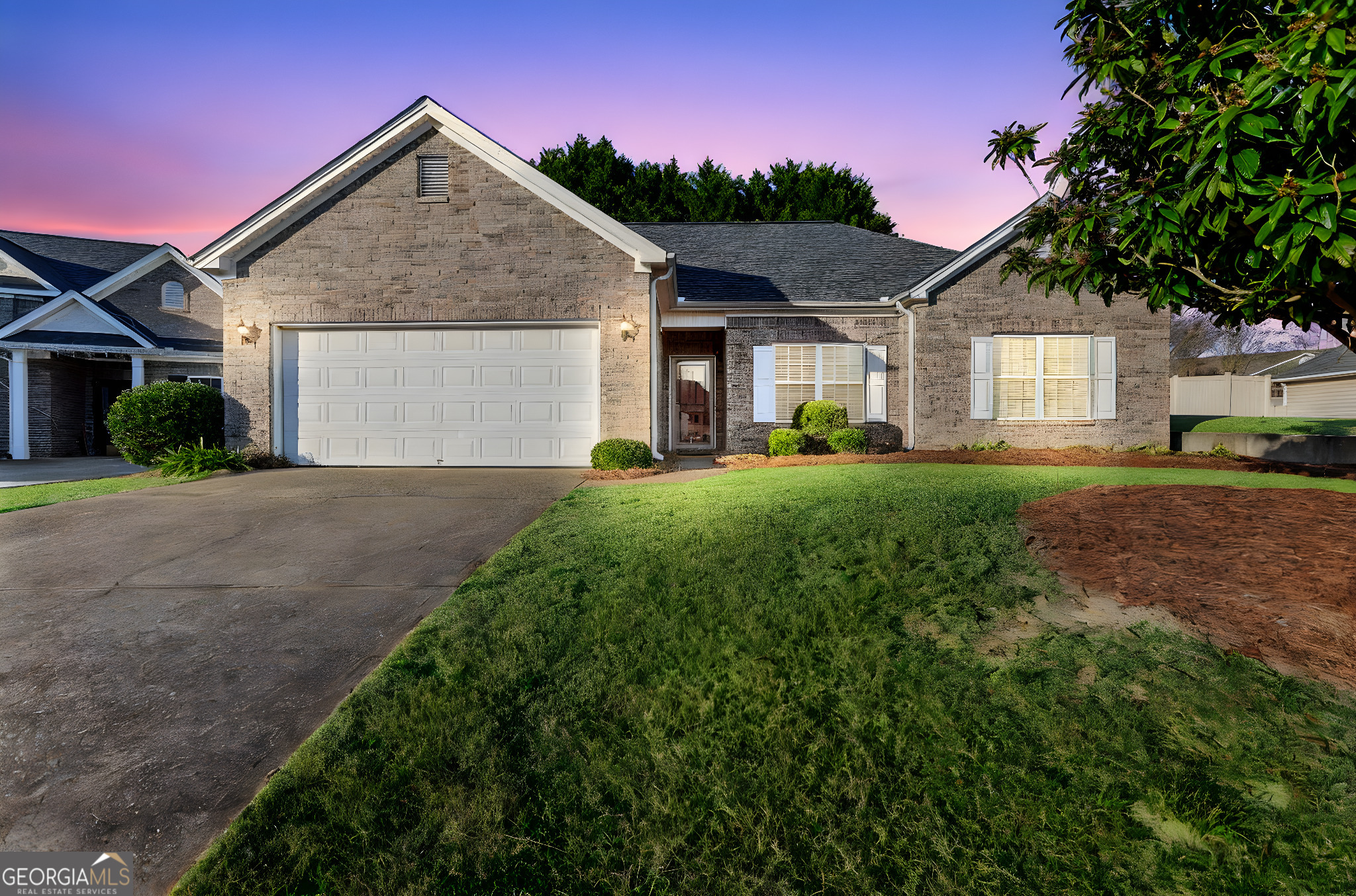 a front view of a house with a yard and garage