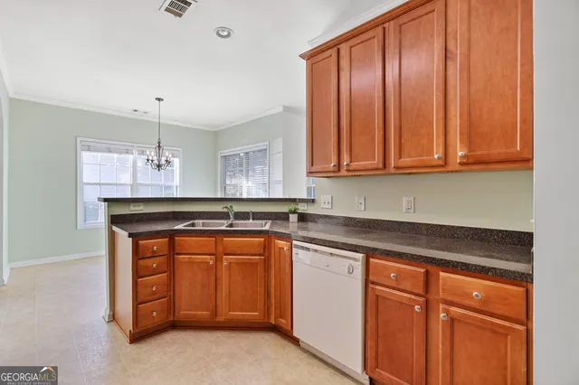a kitchen with granite countertop a sink and cabinets