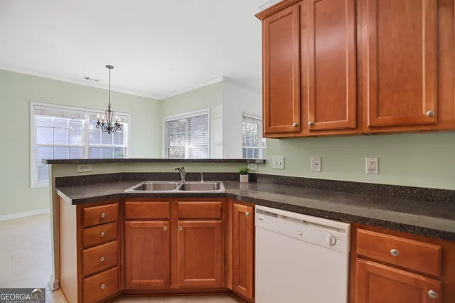 a kitchen with granite countertop wooden cabinets and stainless steel appliances