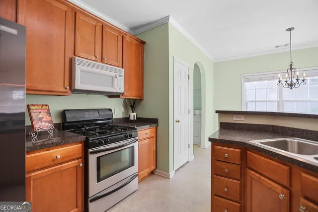 a kitchen with wooden cabinets and a stove top oven