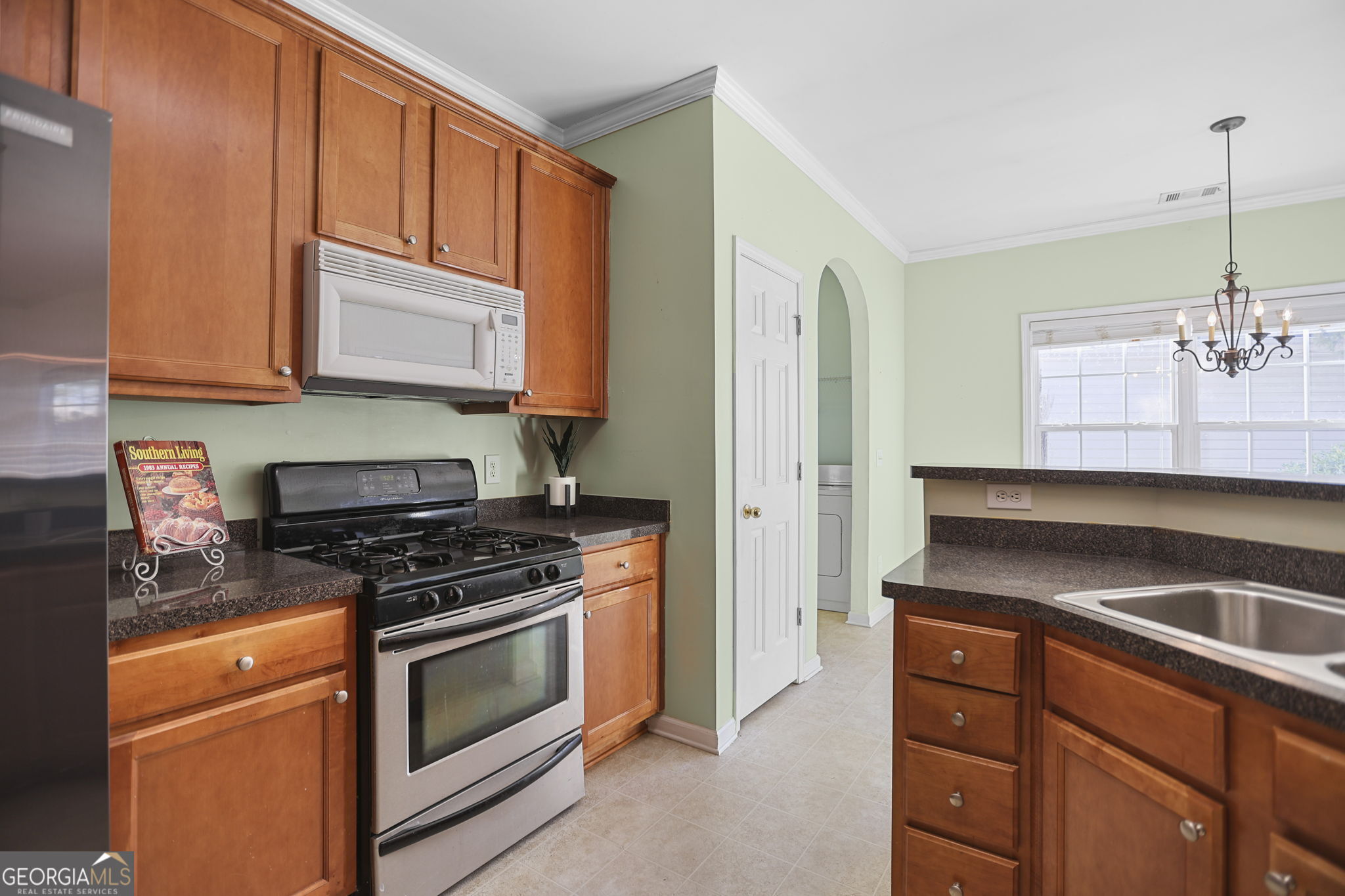 214 Meadow Run Carrollton, GA 30116 - Photo 14 of 44 a kitchen with granite countertop wooden cabinets and stainless steel appliances