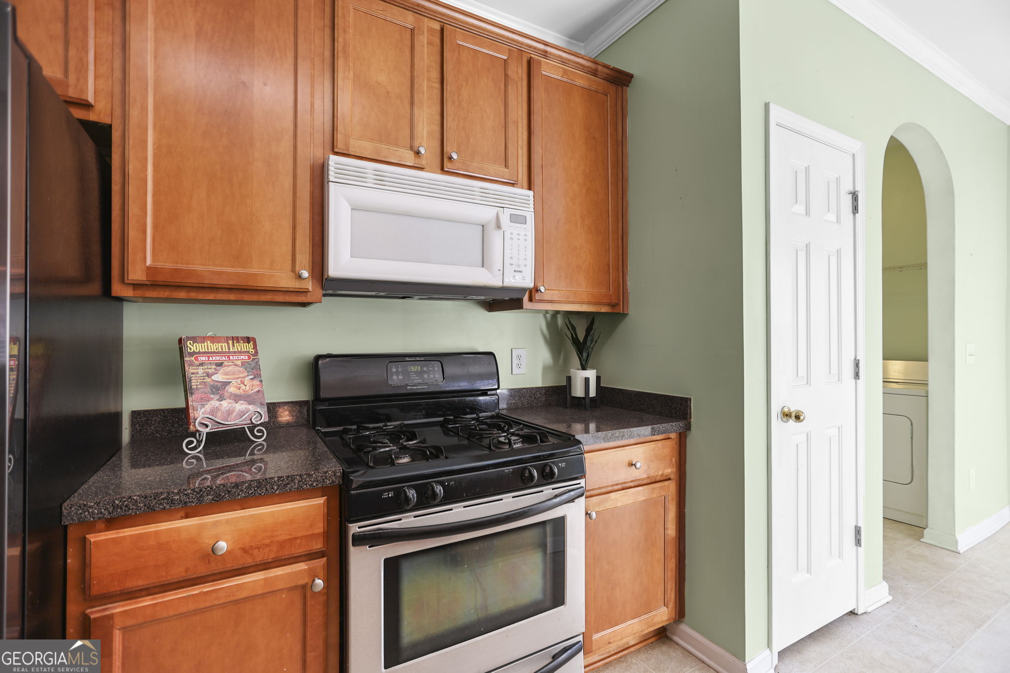 214 Meadow Run Carrollton, GA 30116 - Photo 15 of 44 a kitchen with wooden cabinets and a stove top oven