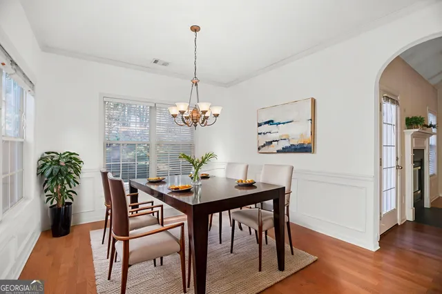 a view of a dining room with furniture wooden floor and chandelier