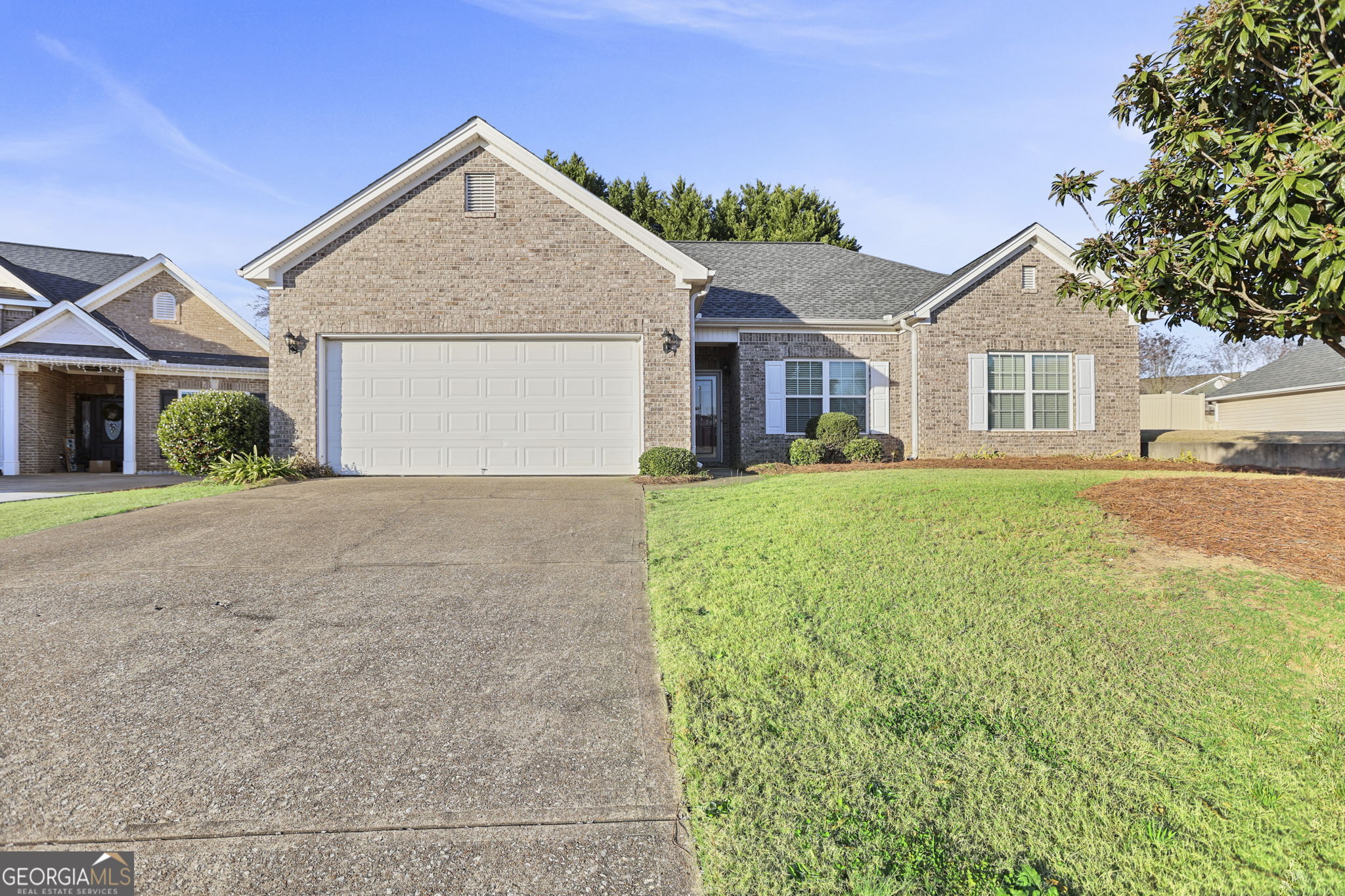 214 Meadow Run Carrollton, GA 30116 - Photo 2 of 44 a front view of a house with a yard and garage