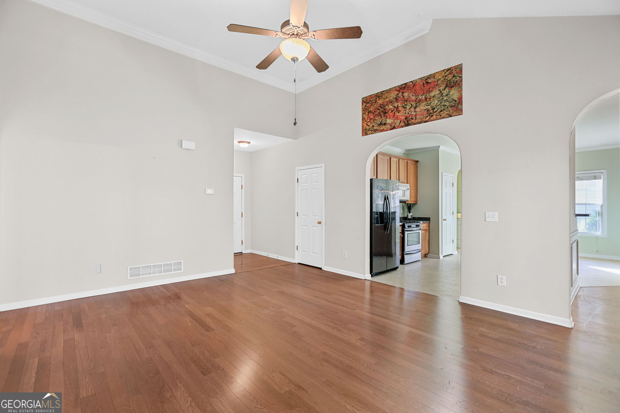 214 Meadow Run Carrollton, GA 30116 - Photo 25 of 44 a view of an empty room with window and wooden floor