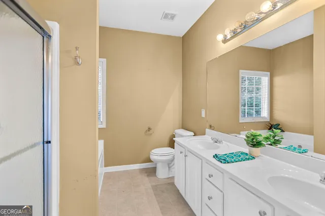 a bathroom with a glass shower door