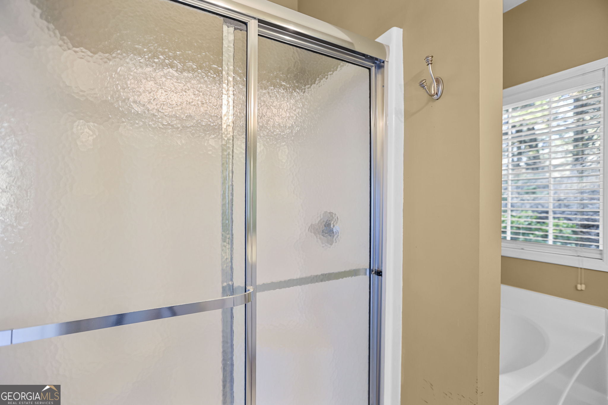 214 Meadow Run Carrollton, GA 30116 - Photo 32 of 44 a bathroom with a glass shower door