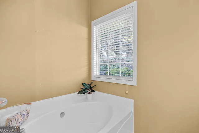 a white toilet sitting next to a white sink and vanity