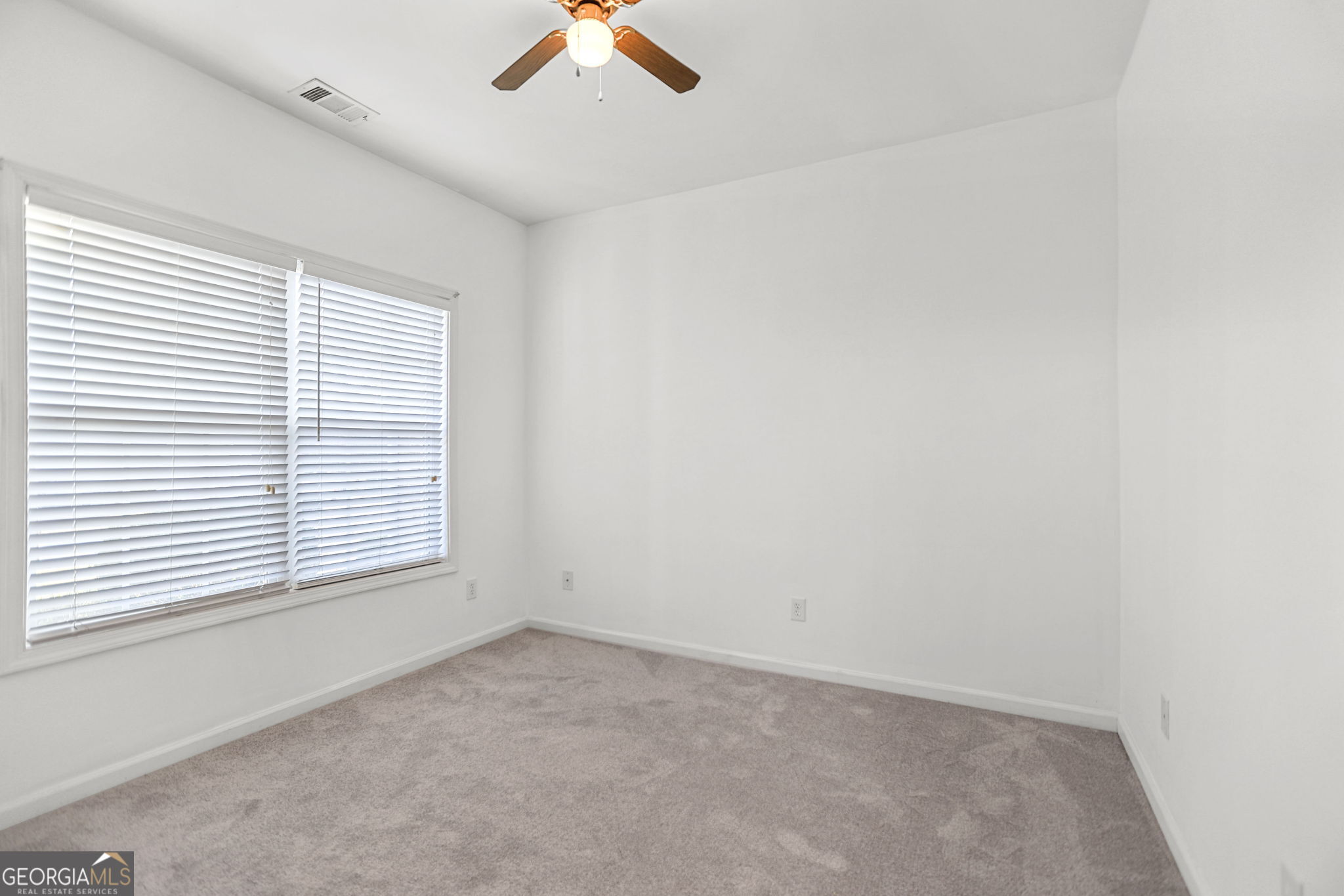 214 Meadow Run Carrollton, GA 30116 - Photo 36 of 44 an empty room with a window and a fan