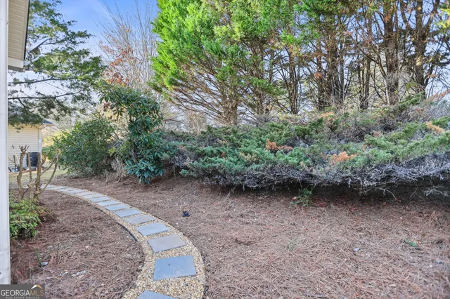 a picture of a open kitchen with a white wall and a refrigerator