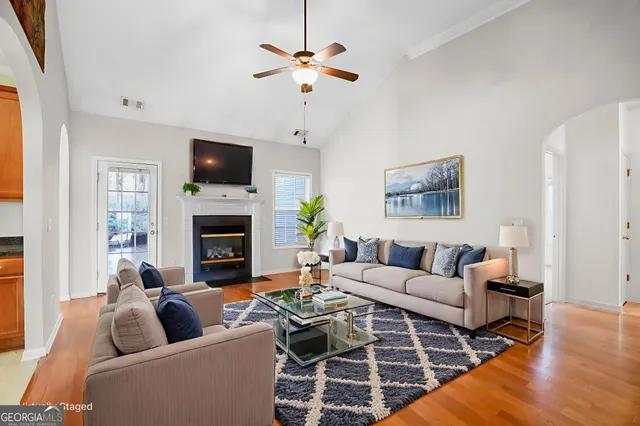 a empty room with a fireplace and wooden floor