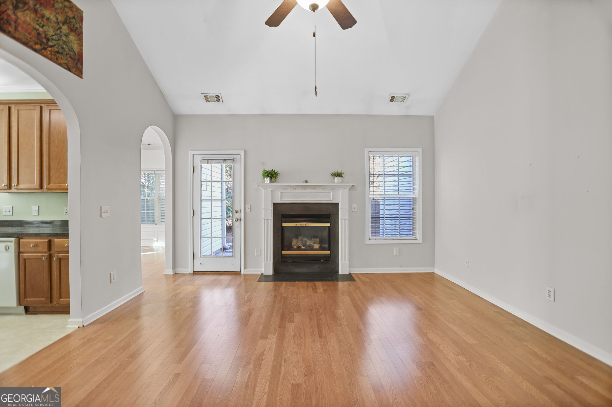 214 Meadow Run Carrollton, GA 30116 - Photo 10 of 44 a empty room with a fireplace and wooden floor