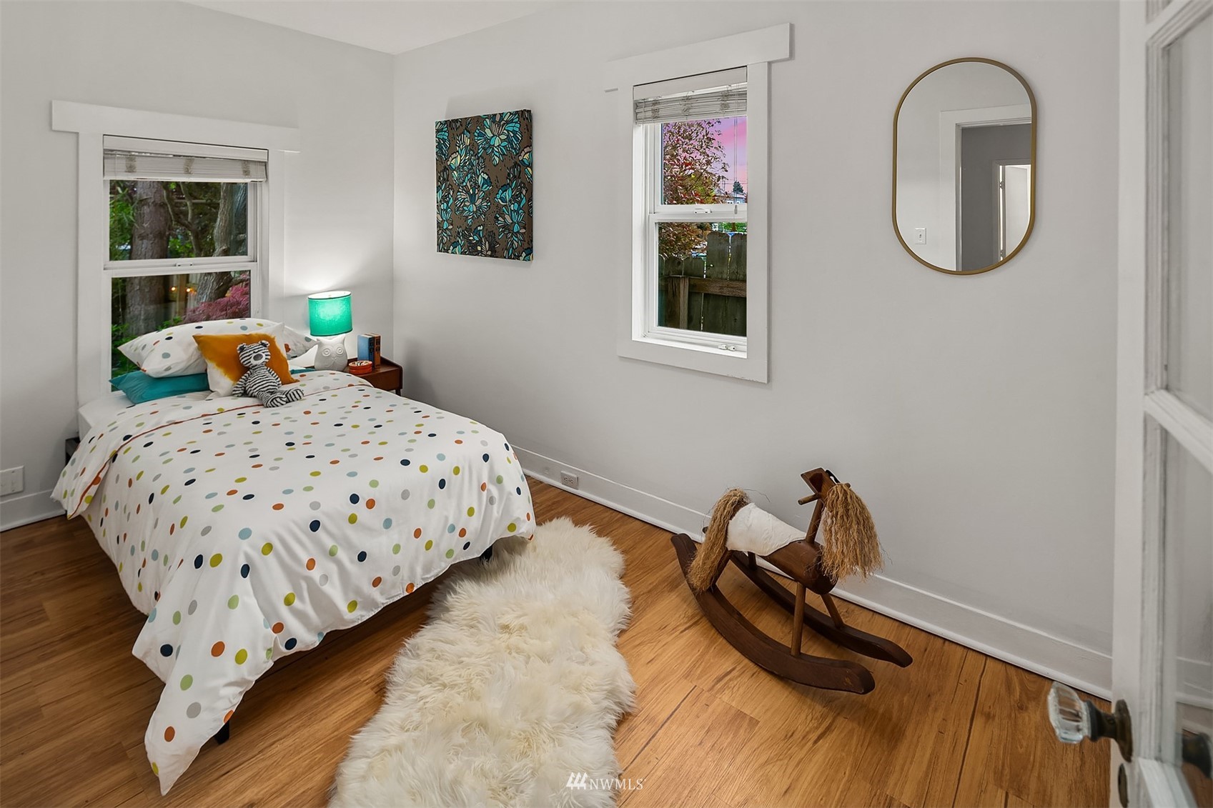 348 North 84th Street Seattle, WA 98103 - Photo 11 of 22 a bedroom with a bed a mirror and a window