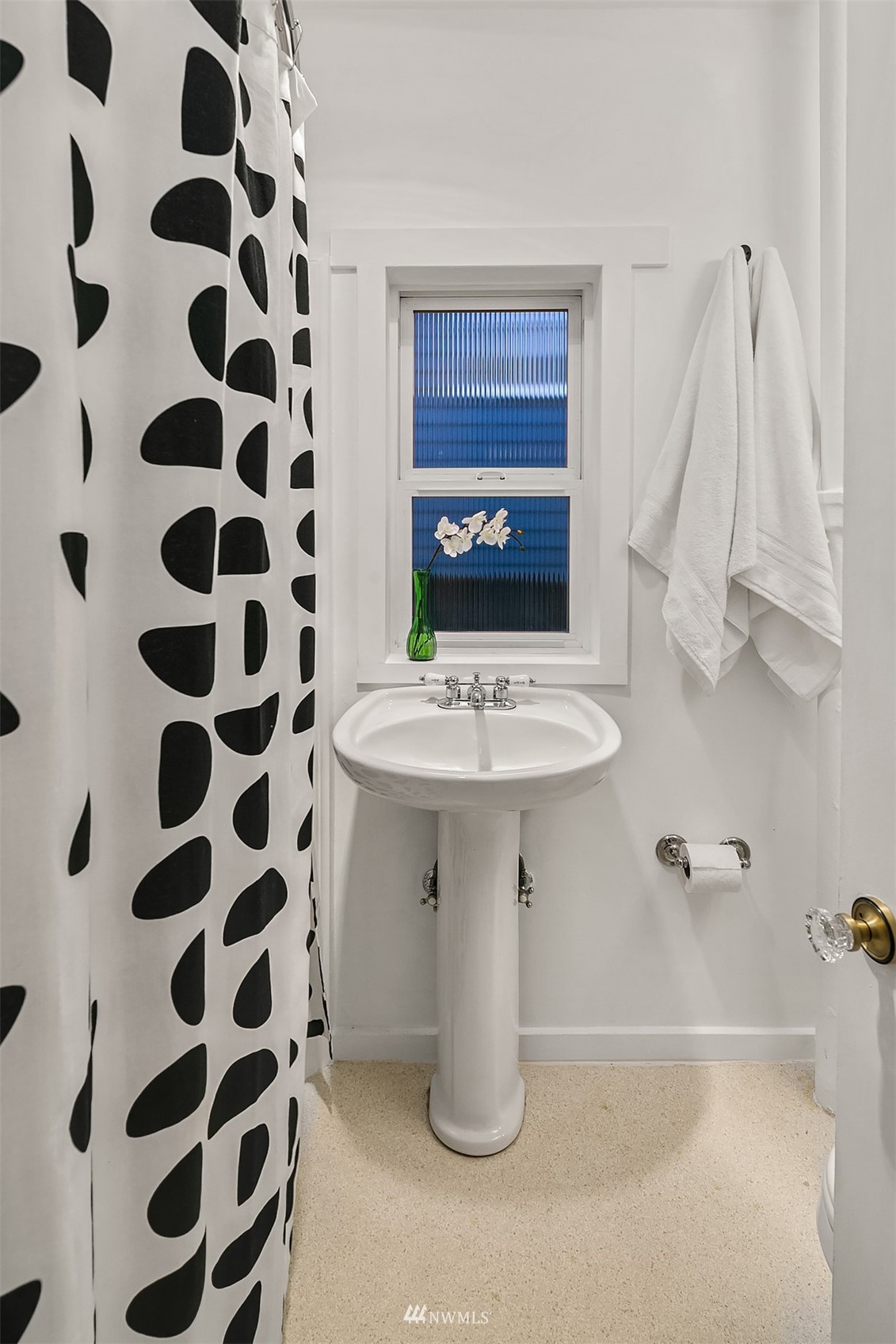 348 North 84th Street Seattle, WA 98103 - Photo 12 of 22 a bathroom with a sink a mirror and a shower