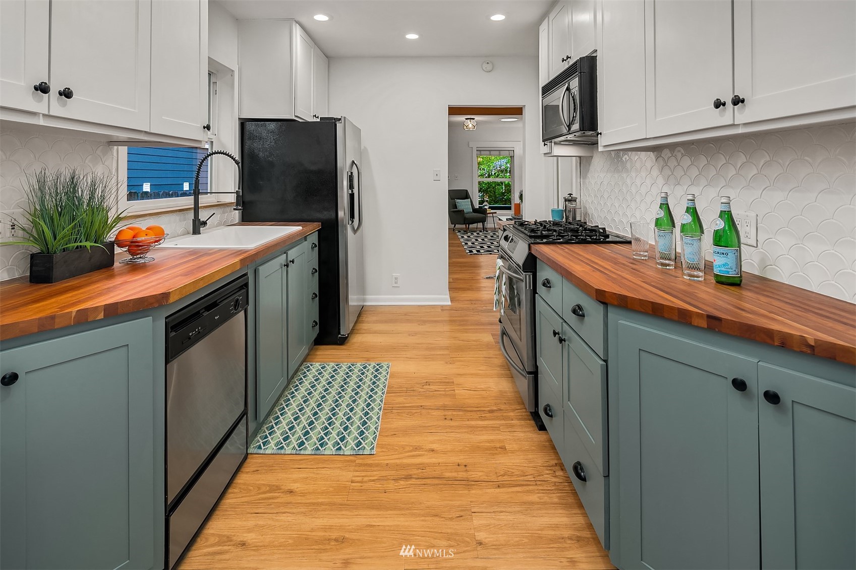 348 North 84th Street Seattle, WA 98103 - Photo 13 of 22 a kitchen with stainless steel appliances granite countertop a sink a counter space and cabinets