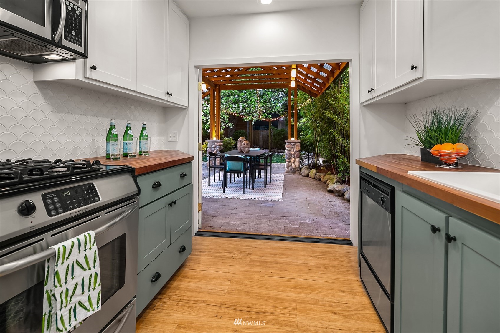 348 North 84th Street Seattle, WA 98103 - Photo 14 of 22 a kitchen with stainless steel appliances granite countertop a stove a sink and a microwave