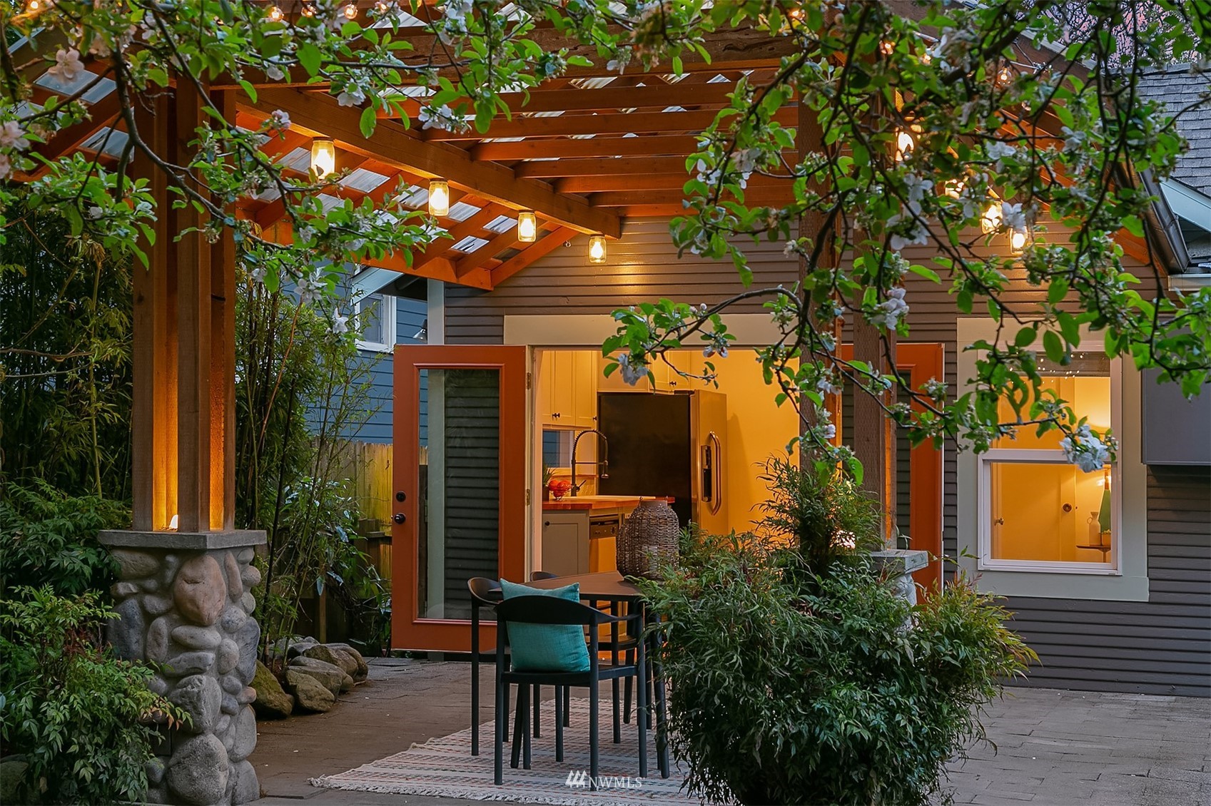 348 North 84th Street Seattle, WA 98103 - Photo 17 of 22 a view of a patio with table and chairs and potted plants