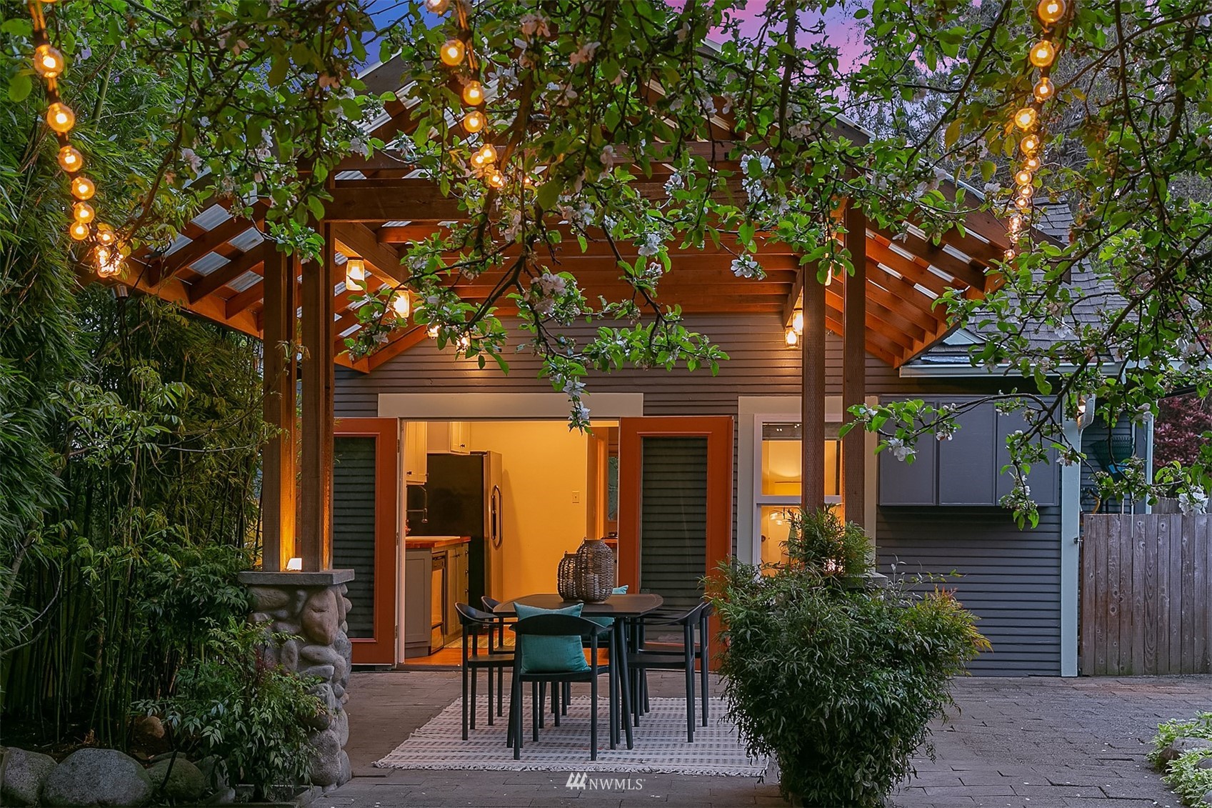 348 North 84th Street Seattle, WA 98103 - Photo 18 of 22 a view of a house with backyard sitting area and garden
