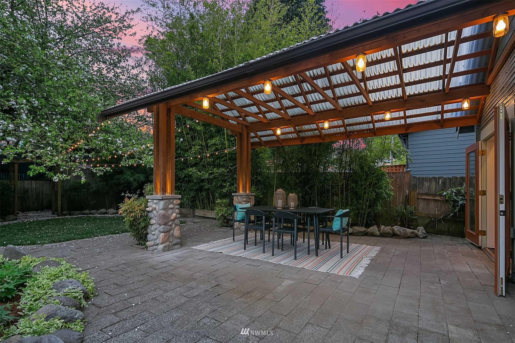 348 North 84th Street Seattle, WA 98103 - Photo 22 of 22 a view of patio with table and chairs and potted plants