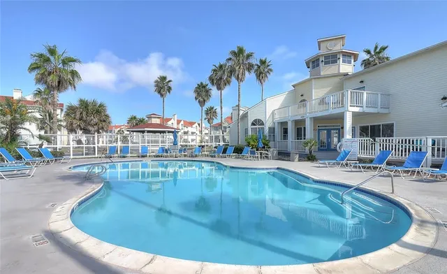 a view of a swimming pool with outdoor seating