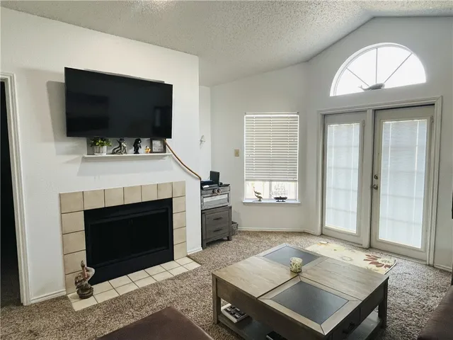 a living room with a flat screen tv and a fireplace
