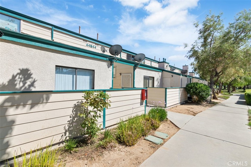 44544 15th Street East, Unit 9 Lancaster, CA 93535 - Photo 14 of 18 a front view of a house with garden
