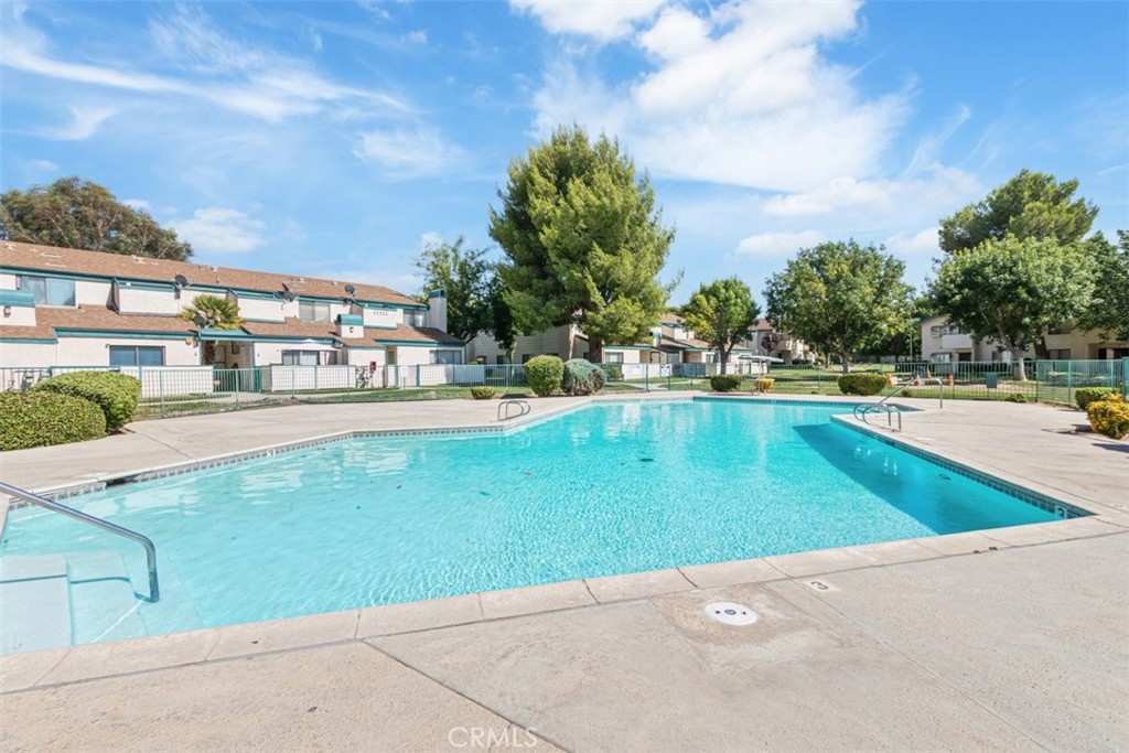 44544 15th Street East, Unit 9 Lancaster, CA 93535 - Photo 16 of 18 a view of a swimming pool and a yard
