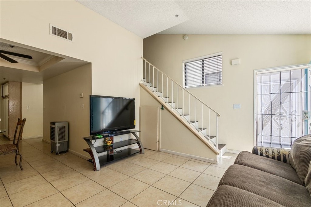 44544 15th Street East, Unit 9 Lancaster, CA 93535 - Photo 2 of 18 a living room with furniture and a flat screen tv